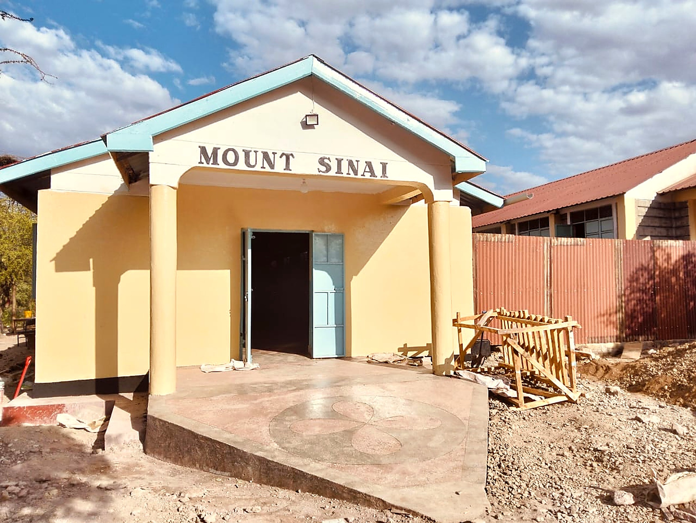 Newly completed Mount Sinai building with fresh paint and finished entrance