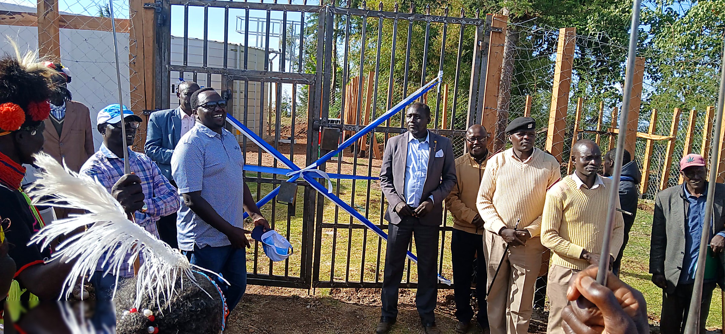 Community leaders in traditional dress at the commissioning of a water project gate