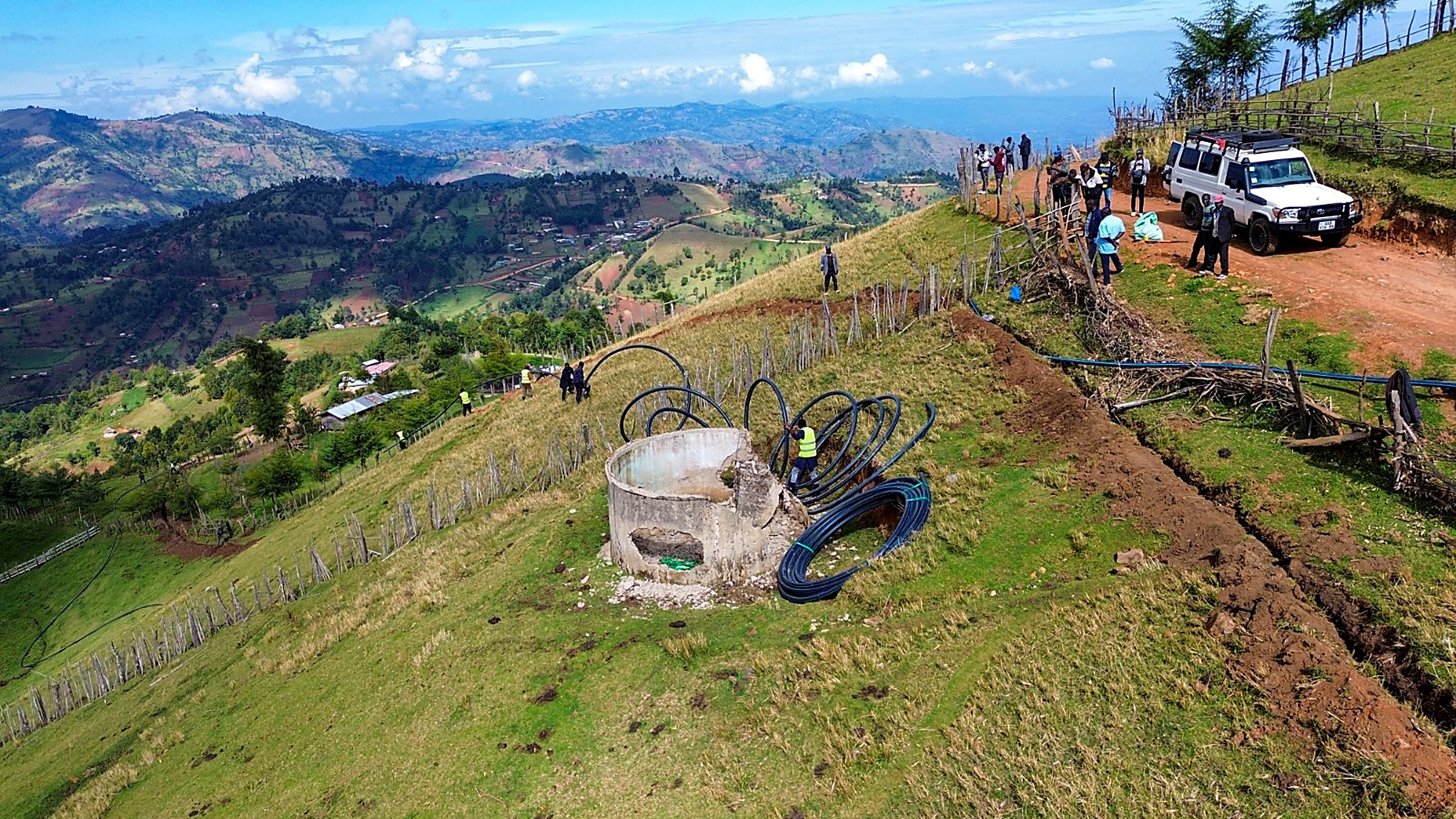 Aerial view of the Sina water project storage tank and pipeline works on a hillside