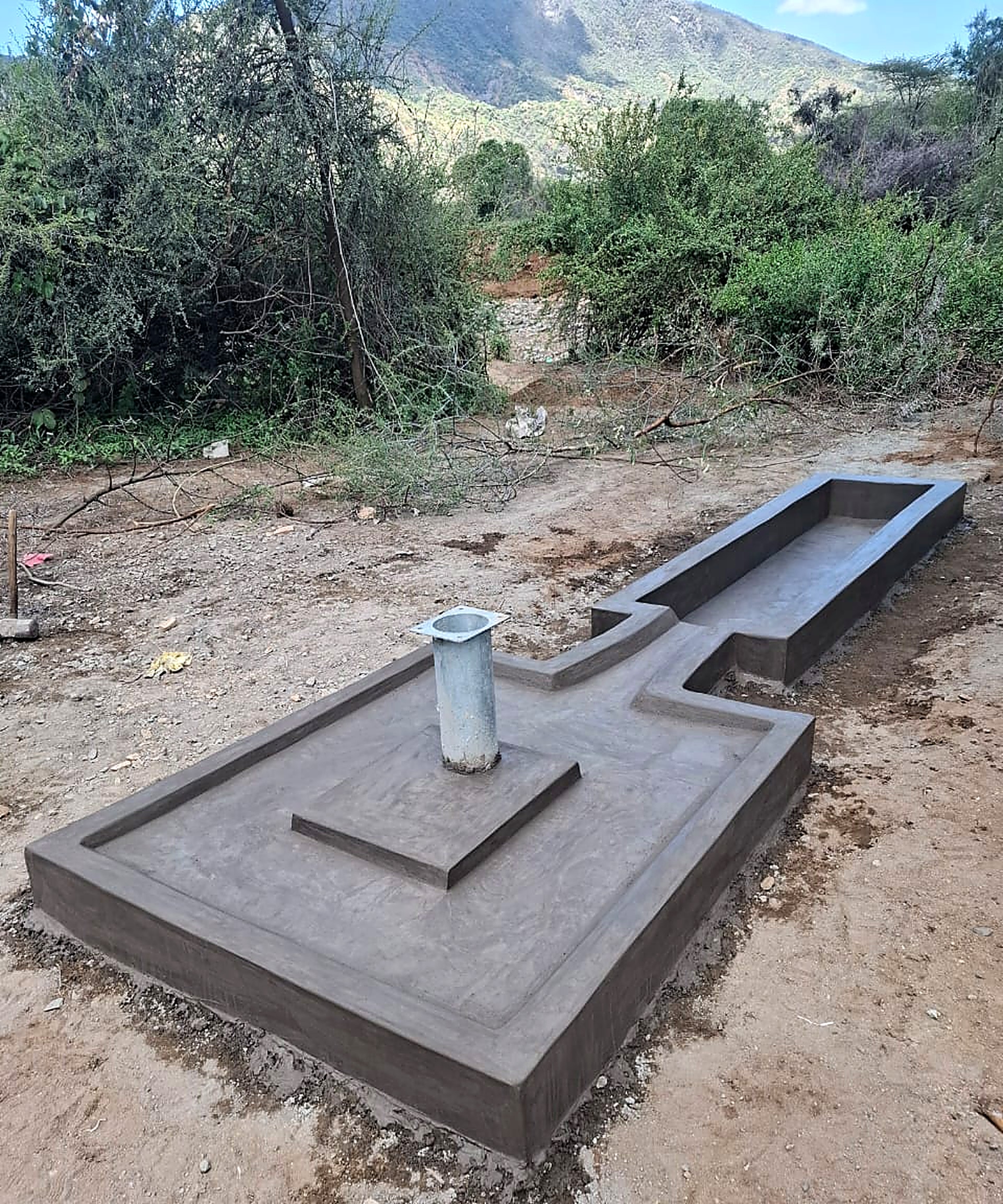 Completed concrete apron and cattle trough at the Rumus borehole site