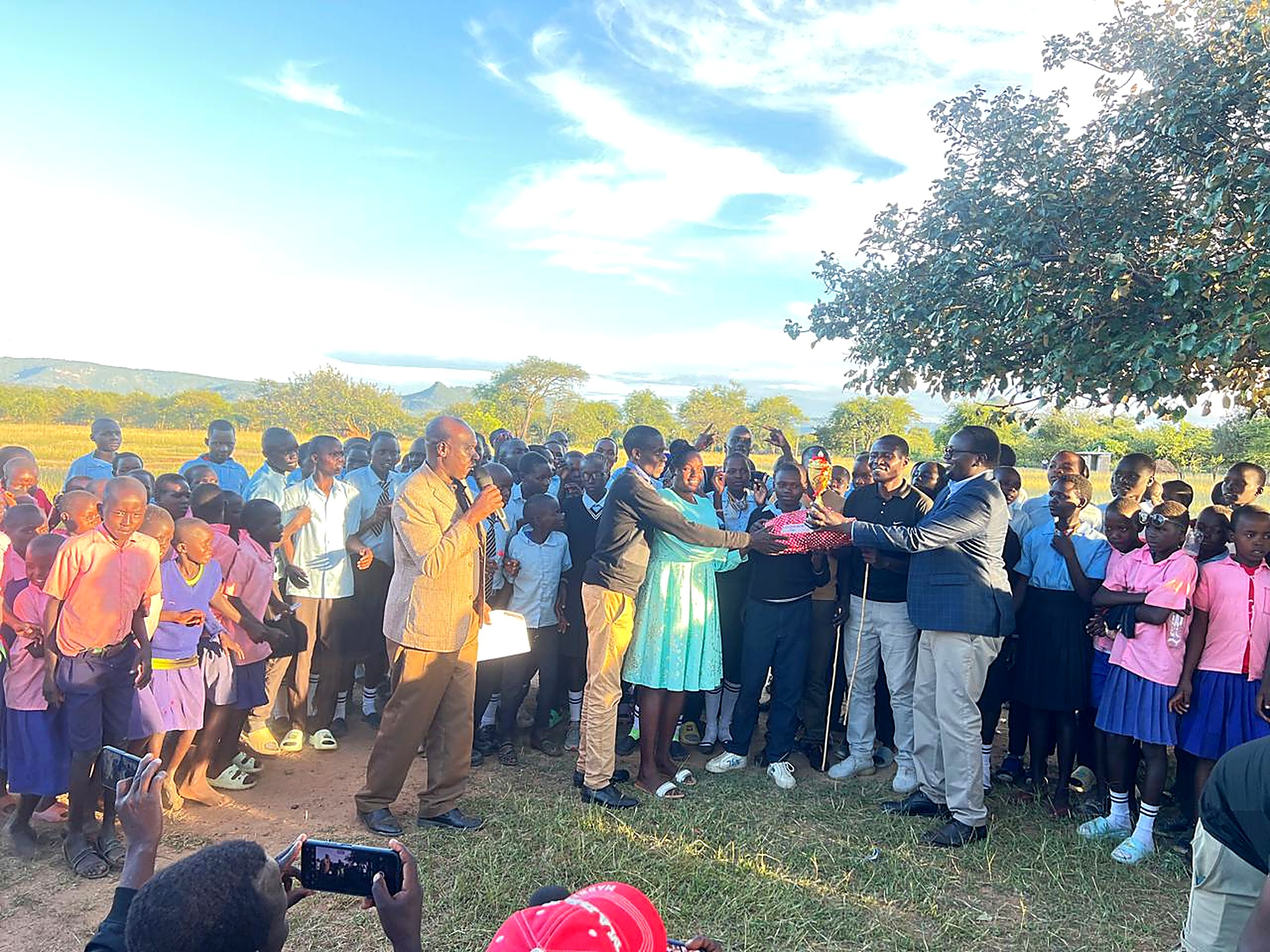 Large gathering of school pupils at an evening outreach and prize giving event